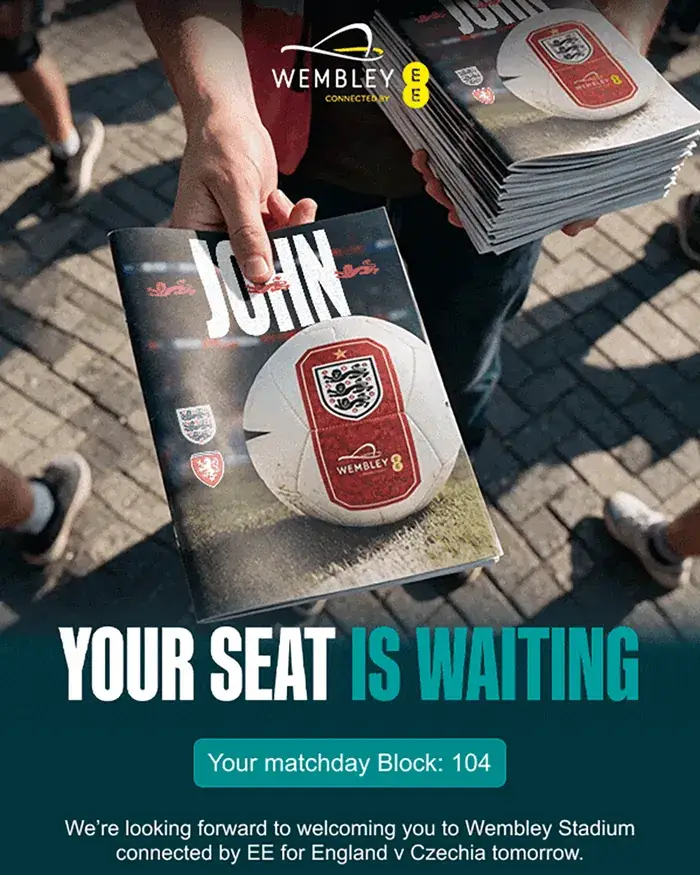 Personalised, animated Wembley hero: a programme seller hands over a matchday programme with John on the cover, above Your seat is waiting, block 104